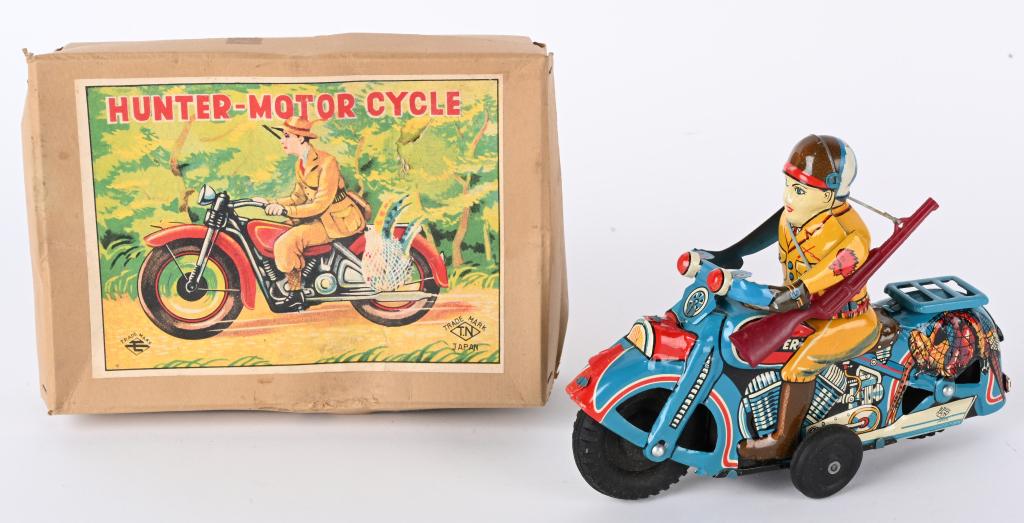JAPAN TIN FRICTION HUNTER MOTORCYCLE w/ BOX: Japan tin friction Hunter Motorcycle. All original and looks never played with. Very nice colors with fowl in the net on back. Still has gun. Friction works. With Box. 4 1/2" Excellent