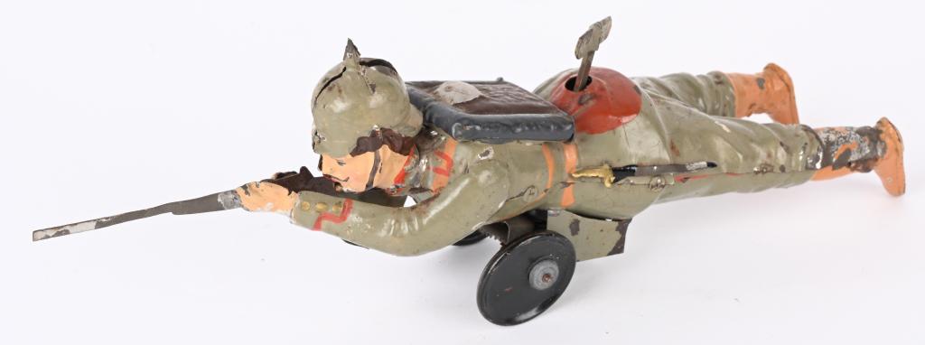 GUNTHERMANN WINDUP PRUSSIAN SOLDIER WITH GUN: German hand painted tin windup Prussian Soldier with Gun. Very nice original paint. Windup works as Soldiers rolls along. 10 1/2" Excellent