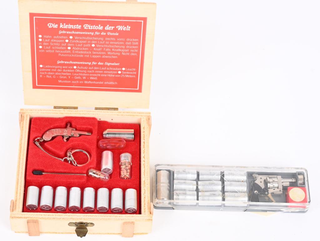 PAIR OF RARE MINITURE PINFIRE FLARE PISTOLS: Both come in the original boxes. One is an Austrian Berioque 2mm colored flare kit in plastic case with cartridges. The other is a Xythos flare set in wooden case with German label, caps, cartridges, 