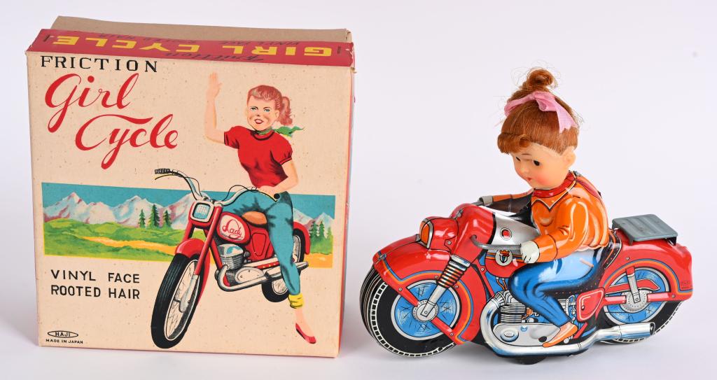 HAJI TIN FRICTION GIRL MOTORCYCLE w/ BOX: Tin friction motorcycle with vinyl head girl rider. All original and works. Looks never played with. With Box 8" Excellent