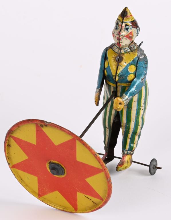 GERMAN TIN WINDUP CLOWN WITH UMBRELLA (1 of 4)