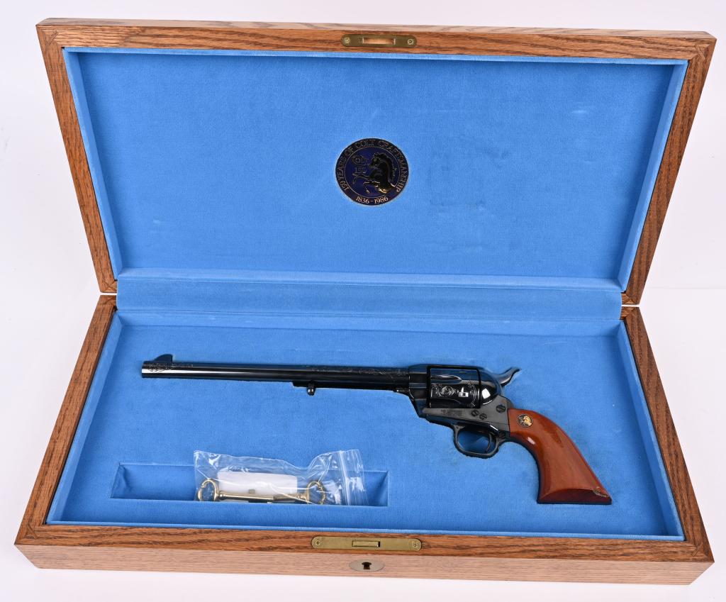 CASED COLT 150TH ANNIVERSARY SAA BUNTLINE: SERIAL AM0314. BARREL 10". CALIBER .45 COLT. MADE IN 1986. Special features include engraving on barrel & cylinder, full blue finish, smooth one piece walnut grips with special medallion. Special 150t