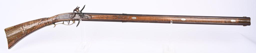 CUSTOM JACK FULLER SWIVEL BREECH FLINTLOCK RIFLE: BARREL 38". CALIBER 44. SIGNED ON BARREL FLAT. Features two full length octagon barrels, blade rear sights, small knife front sights, full length curly maple stock, flintlock, brass furniture, iron ha