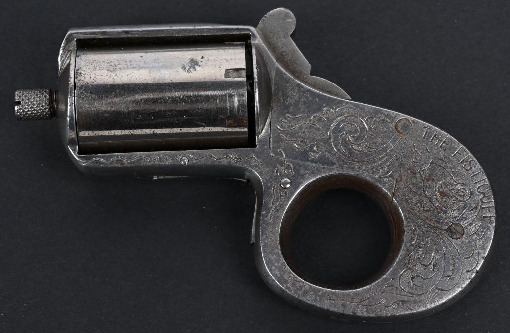 FACTORY ENGRAVED "THE FISTICUFF" KNUCKLEDUSTER: SERIAL NUMBER 33 BARREL 1-3/8" CALIBER .22 RIM FIRE MANUFACTURED CIRCA 1870'S. A French copy of the Reid 'My Friend" Knuckle Duster with coin finished exterior and engraved with broad scrolls and vine