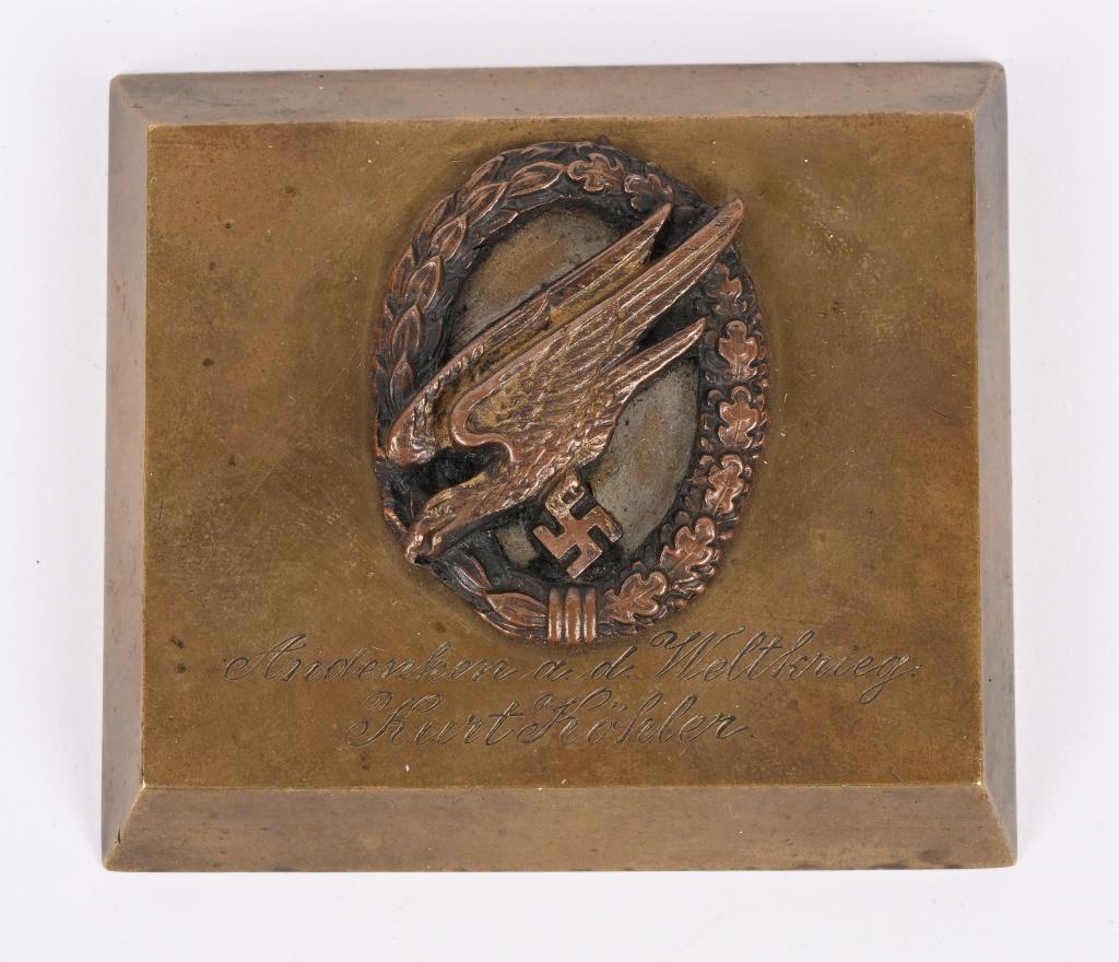 WWII NAZI GERMAN PARATROOPER DESK PLAQUE WW2: WWII Nazi German Paratrooper desk plaque measuring 3 1/4 X 2 7/8 inches being comprised of a Fallschirmjäger badge mounted on a solid brass plate with the inscription "Andenken a. d. Weltkri