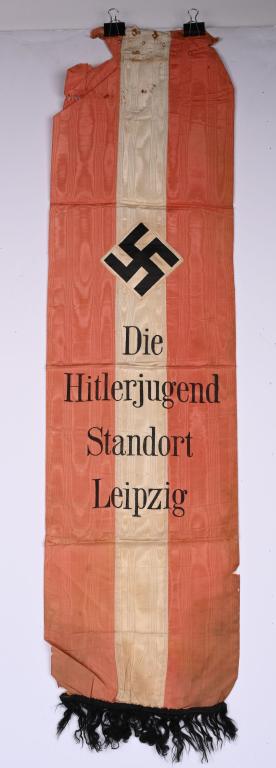 WWII NAZI GERMAN HITLER YOUTH LEIPZIG FLAG WW2: Small banner made of rayon measures 10 1/2 X 41" being multi piece construction with the text Die Hitlerjugend Standort Leipzig with a black mobile swastika above. Very Good. Besides the HJ