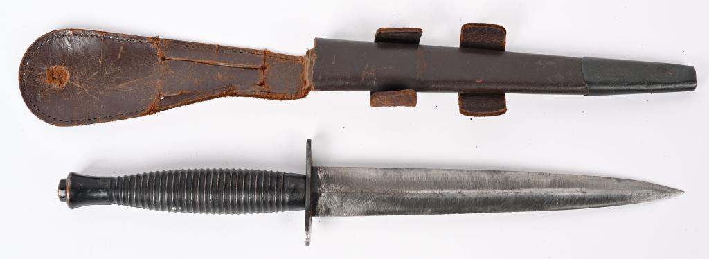 WW2 BRITISH FAIRBAIRN SYKES FIGHTING KNIFE SHEATH: A third pattern Fairbairn-Sykes fighting knife with a 17cm stiletto style blade with high central spine. The blade in good condition with light surface spotting. The cast blackened brass handle has tw