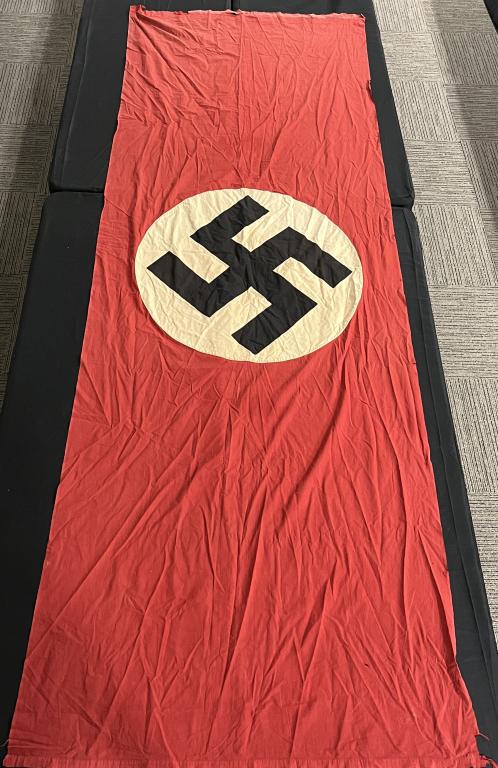 WWII NAZI GERMAN NSDAP WALL BANNER FLAG WW2: Multi-piece cotton construction banner approximately 144 x 50 inches. To both its red fields are sewn have white disks with a multi piece mobile swastikas in black. Shows several rips and tears a