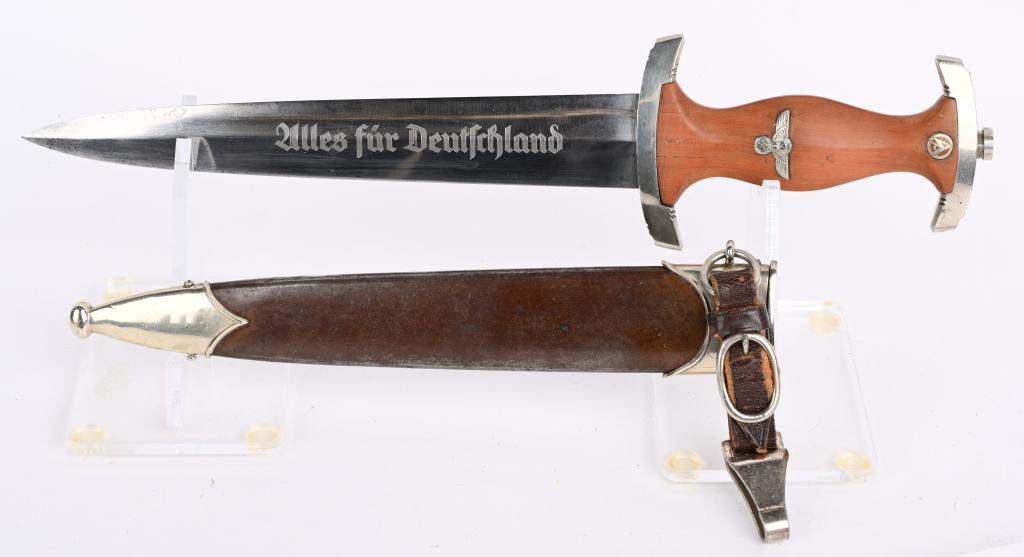 WWII NAZI GERMAN SA DAGGER BY PUMA w/ SCABBARD WW2: SA dagger with a 22cm long double-edged drop-forged nickel-silver plated blade in its original scabbard. The dagger has a cast nickel-silver plated pommel and tang nut. Its contoured wooden grip has i