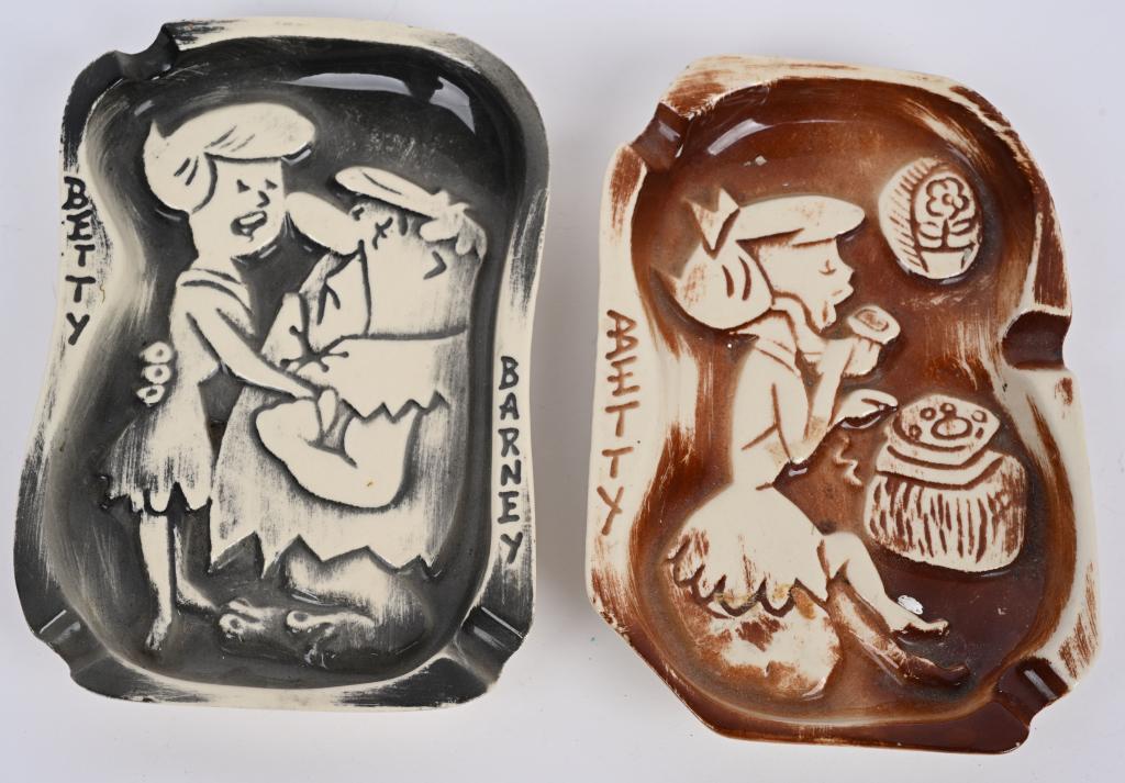 2- ARROW FLINTSTONES CERAMIC ASH TRAYS: 2- Arrow Houseware Flintstones Ceramic Ash Trays. Includes Betty and Betty with Barney. Both dated 1961. All original and in great condition. 8" Excellent