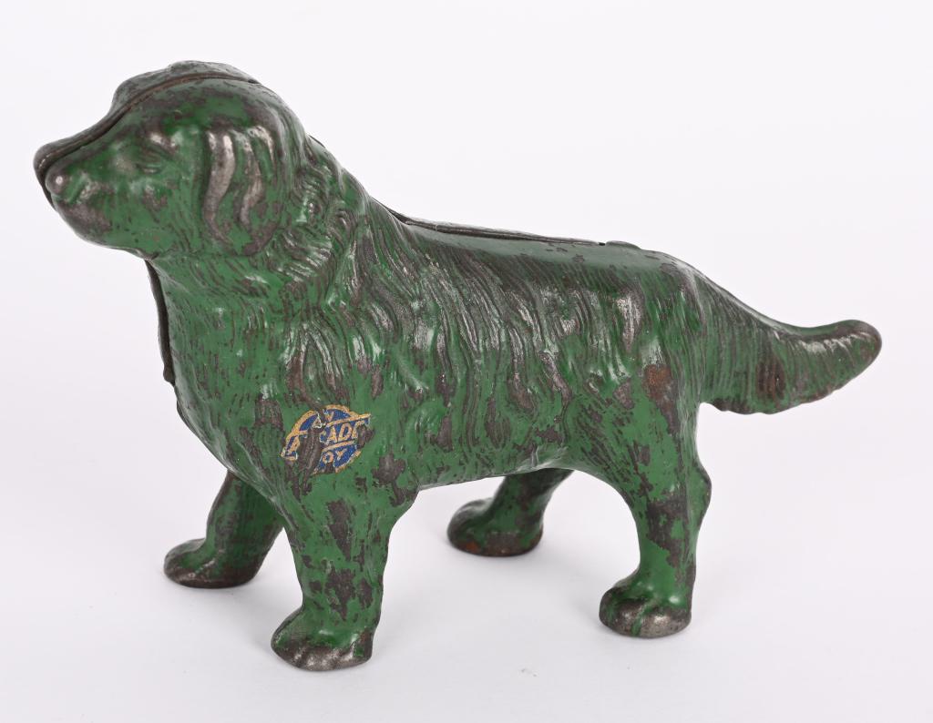 ARCADE CAST IRON NEWFOUNDLAND STILL BANK: Arcade cast iron Newfoundland Dog Still Bank. All original with decent green paint. Has Arcade sticker. No breaks or repairs. 3 5/8" Excellent