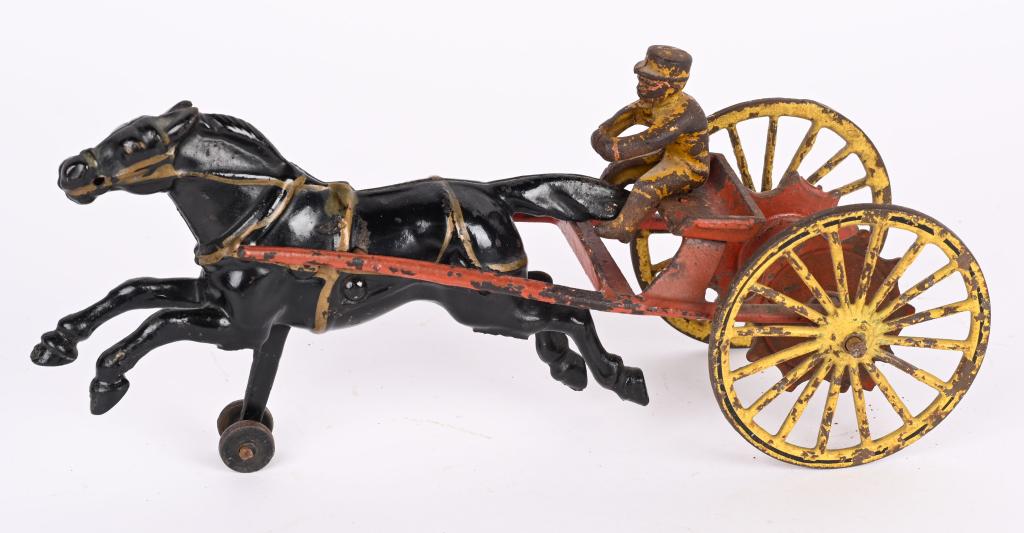 WILKINS CAST IRON HORSE DRAWN HOSE REEL: Original circa 1895 Wilkins Hose reel. Driver is an original cast iron driver but not correct for this toy. Measures 10 1/4", No cracks or repairs. Very Good-Excellent