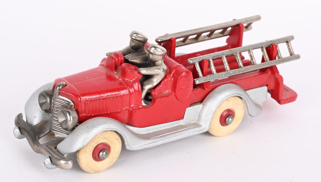 HUBLEY CAST IRON FIRE LADDER TRUCK: Hubley cast iron fire ladder truck, made of multiple castings. All original silver and red paint with original white rubber tires and original drivers. Nickel plated drivers, ladders, boiler and grill