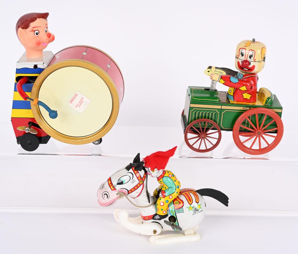 3-JAPAN TIN WINDUP CLOWNS: Lot includes a Clown Crazy Carm a Clown Drummer missing on drum stick, and a Tin Clown on hopping horse. All worked when tested. Largest is 6", Excellent