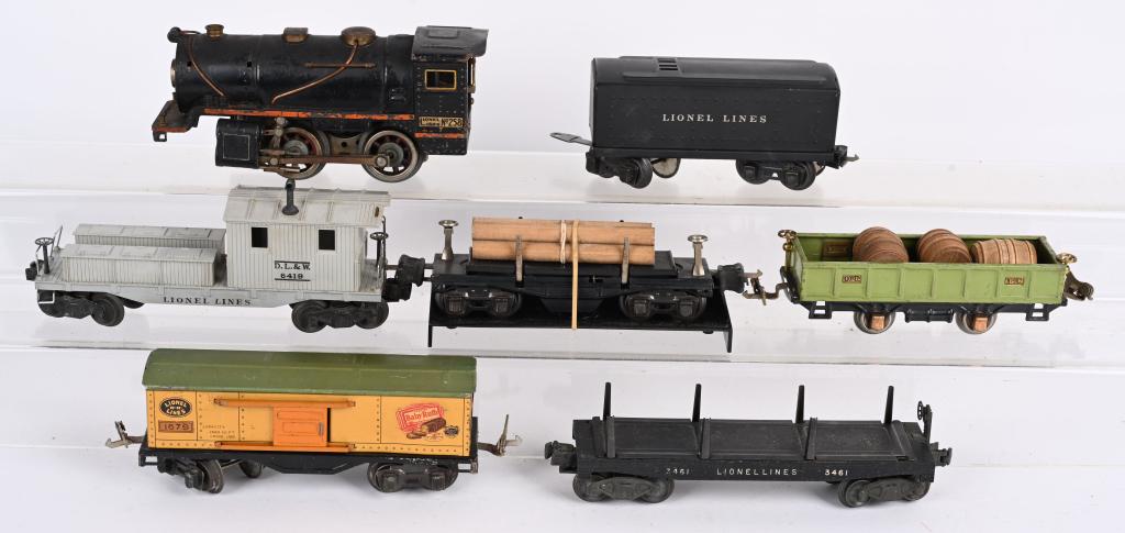 LIONEL 258 LOCOMOTIVE & TENDER w/ CARS: Includes 258 Locomotive and 1689T Tender. Plus3461 Operating Flat car., 902 Gondola, 1679 Baby Ruth car, Dumping Flat Car, and 6410 Working Caboose. Some missing parts and wear. Very Good