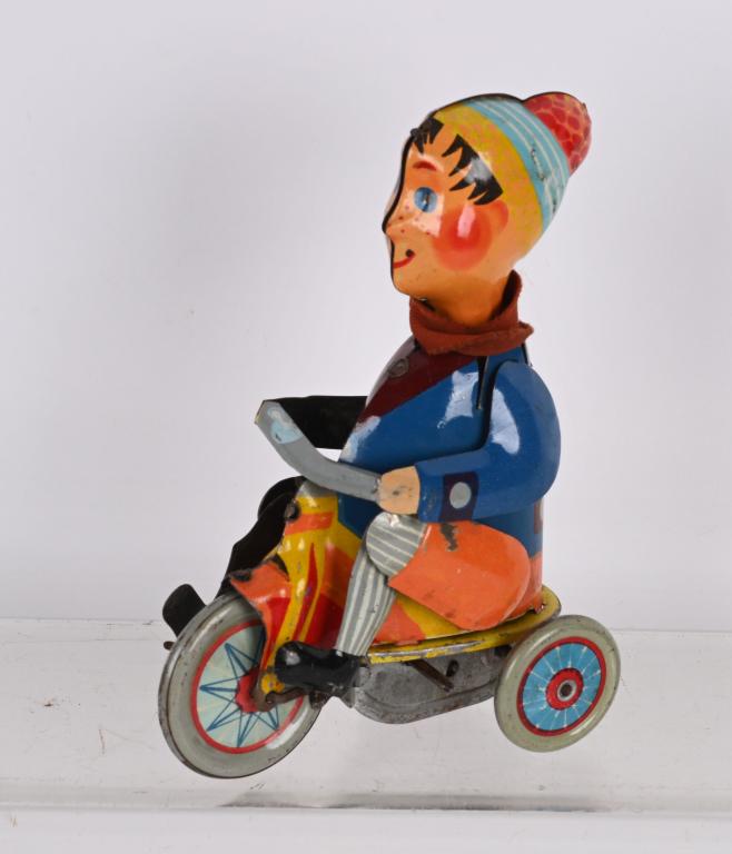 UNUSUAL TIN WINDUP BOY ON TRIKE (1 of 3)