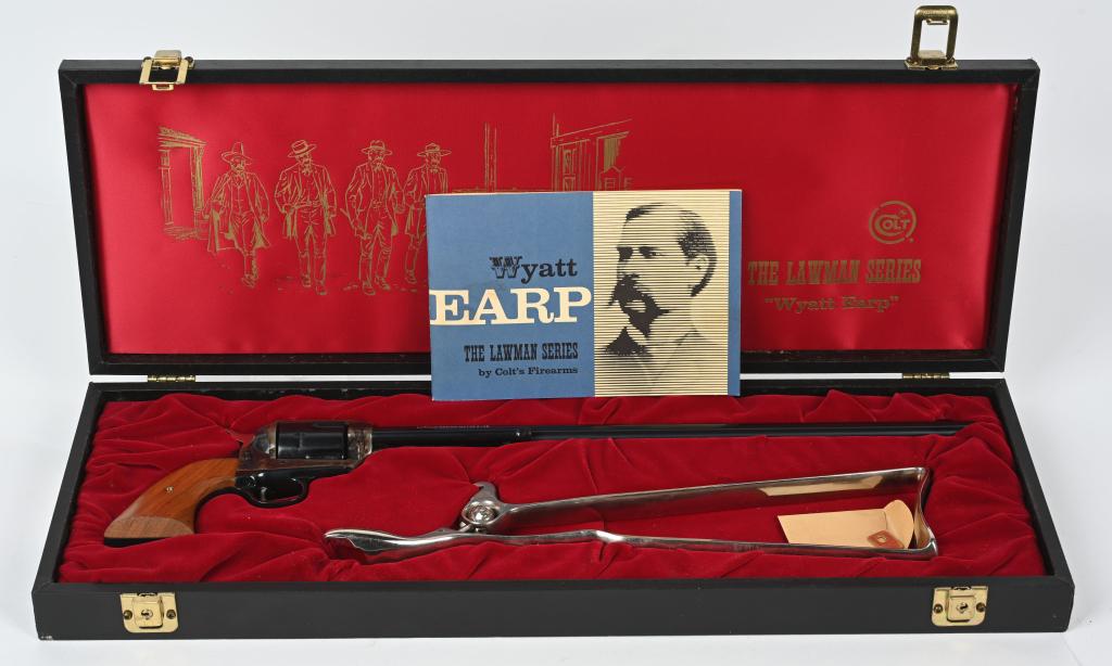 CASED COLT WYATT EARP LAWMAN BUNTLINE SAA REVOLVER: SERIAL 381WYE. BARREL 16". CALIBER 45 COLT. 1 OF 500 MADE IN 1970. This beautiful revolver features a flat top frame with inset target rear sight, blue and case color finish, walnut grips and nickel p