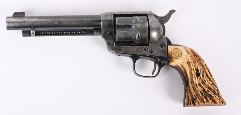 PRE WAR COLT 1ST GEN SAA REVOLVER: SERIAL 346307. BARREL 5.5". CALIBER 38-40. MADE IN 1923. Standard blue and case color with stag grips that have two Mexican 2-peso gold coins for medallions. Single serial number on frame. Condition. 