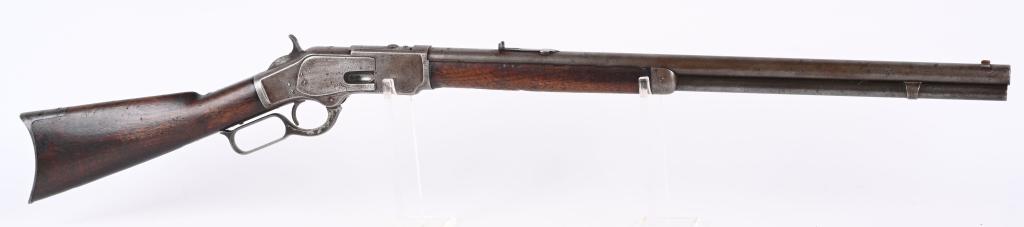 1ST MODEL RAISED THUMB PRINT 1873 WINCHESTER RIFLE: SERIAL 4234. BARREL 24". CALIBER 44-40. MADE IN 1875. Besides rare raised thumb print cover, rifle features a full round barrel, full magazine, small semi buckhorn rear sight with walnut stock that ha
