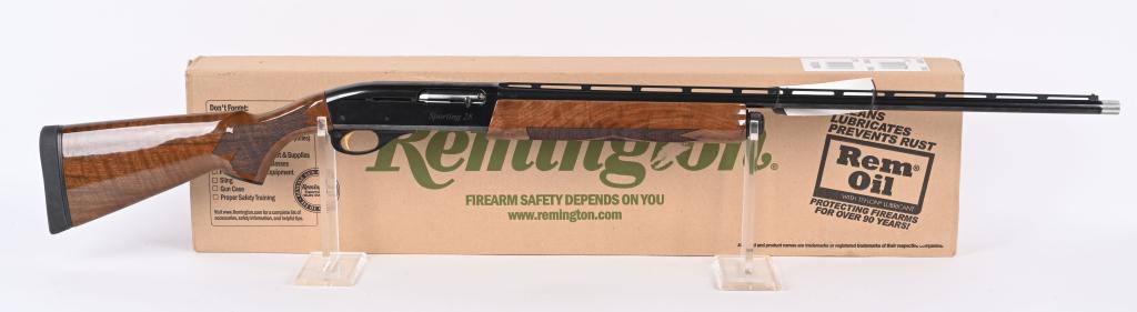 BOXED 28 GA, REMINGTON MODEL 1100 SHOTGUN: SERIAL RS5683OU BARREL 27". GAUGE 28. CHAMBER 2 3/4". REM-CHOKE SYSTEM. Features vent rib, blue finish, take down, deluxe hand checkered pistol grip walnut stock with straight comb and solid black rec