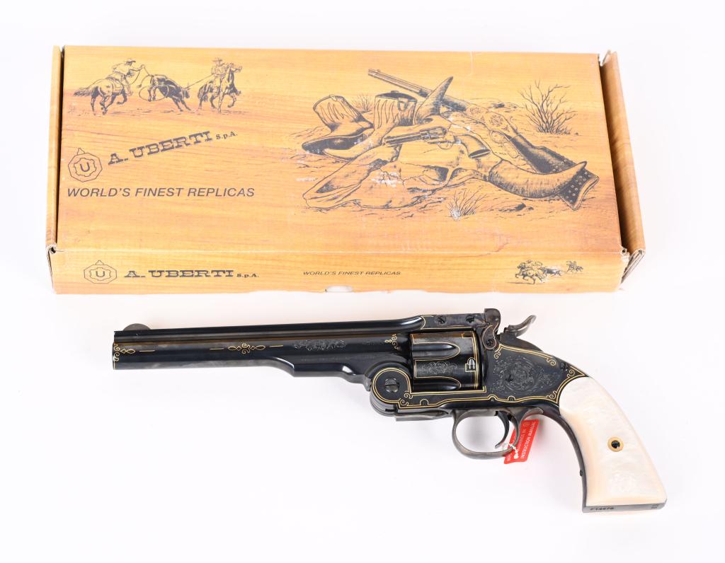 BOXED DELUXE ENGRAVED UBERTI SCHOFIELD REVOLVER: SERIAL F14478. BARREL 7". CALIBER .45 COLT. US Schofield that features a blue frame, case color trigger guard , latch and hammer with faux pearl grips as well as original walnut grips. Beautifully eng