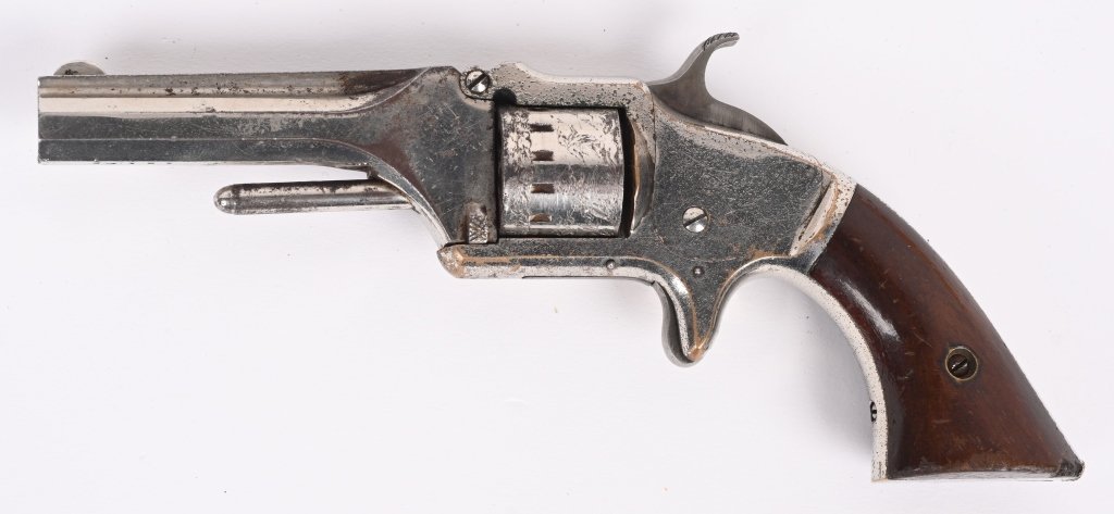 AMERICAN STANDARD SEVEN SHOT REVOLVER: SERIAL 24197. BARREL 3". CALIBER .22. Basically a copy of the S&W, seven shot, spur trigger, nickel finish, case color hammer, rosewood grips, ribbed octagon barrel. Condition. Nice example retains ab