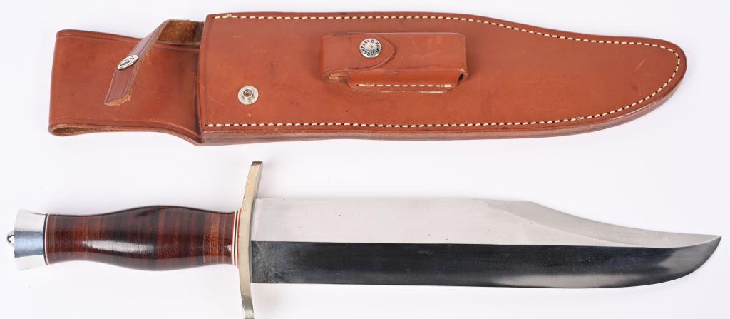 RANDALL MOD 12 SMITHSONIAN BOWIE KNIFE: Massive 11" carbon steel blade with RANDALL MADE touch mark on left side. Forward swept double nickel silver guard with sole leather handle and albumin butt cap. Smooth Back Randall marked scabbard wi