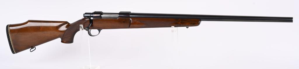 SAKO FORRESTER MODEL L579 BOLT RIFLE: SERIAL 79720. BARREL 24". CALIBER .243. MADE IN FINLAND. Features heavy round barrel not cut for barrel sights. blue finish, built in scope ring rails, checkered walnut pistol grip stock with Monte Ca