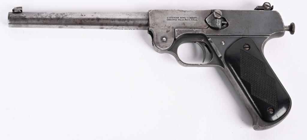 STEVENS MODEL 10 .22 SINGLE SHOT TARGET PISTOL: SERIAL NUMBER 8818 BARREL 8" CALIBER .22 LONG RIFLE MANUFACTURED 1919-39. Blue finished with tip-up single shot action. Manual cocking striker fired with adjustable rear sight and 2 piece checkered ha