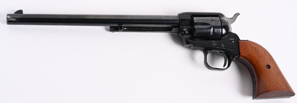 COLT FRONTIER SCOUT BUNTLINE .22 REVOLVER: SERIAL 28618P. BARREL 9.5". CALIBER .22 LR. MADE IN 1965. Features full blue finish, six shot fluted cylinder, fixed sights, two piece walnut grips, light engraving on butt. Condition. Wear at muzzle,