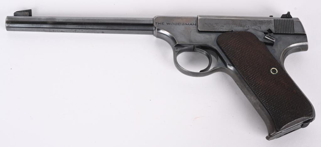PRE-WAR COLT WOODSMAN 22 PISTOL: SERIAL NUMBER 120905 BARREL 6 5/8" CALIBER 22 LONG RIFLE. Manufactured 1937. Blue finish with checkered walnut grips panels. Adjustable rear sight with adjustable front sight. 10 round two tone magazi