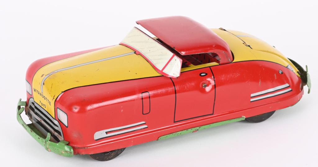 WYANDOTTE TOY PRESSED STEEL WINDUP CONVERTIBLE: Nice original toy. Has bright paint and a working windup motor. The top goes up and down and the truck opens. Original tires have wear. 13", Excellent