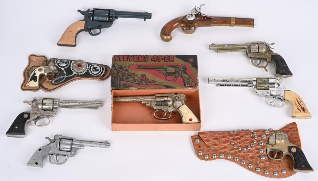 9- VINTAGE CAP GUNS, STEVENS 49er w/ BOX & MORE: Lot includes a cast iron Stevens 49er with original box, a Fanner 50 , a Nichols Stallion 38 , a Champion pistol, a Davy Crockett flintlock pistol and more. All have problems and are good for parts or