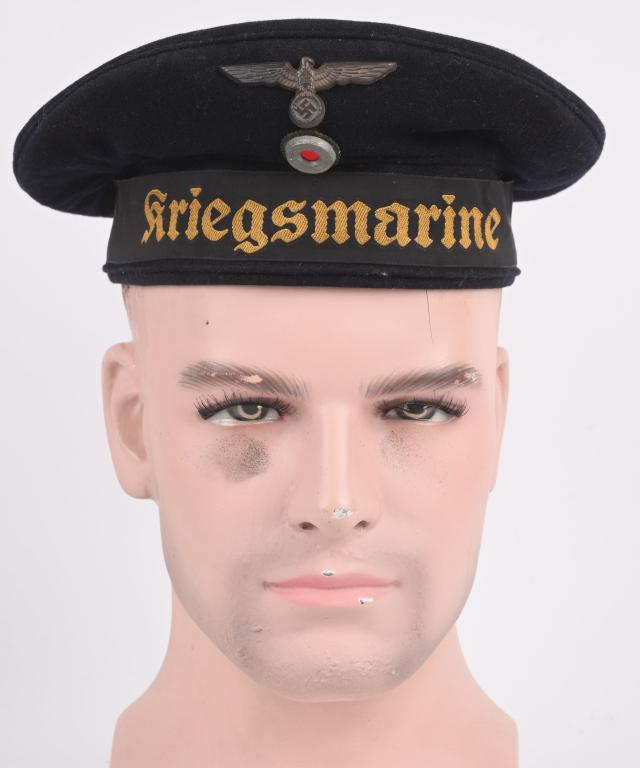 WWII NAZI GERMAN KRIEGSMARINE DONALD DUCK HAT WW2: Deep navy blue doeskin wool construction "Donald Duck" style sailor’s cap features a one piece, circular crown and two piece side panels with machine stitched vertical seams to each side. The fr