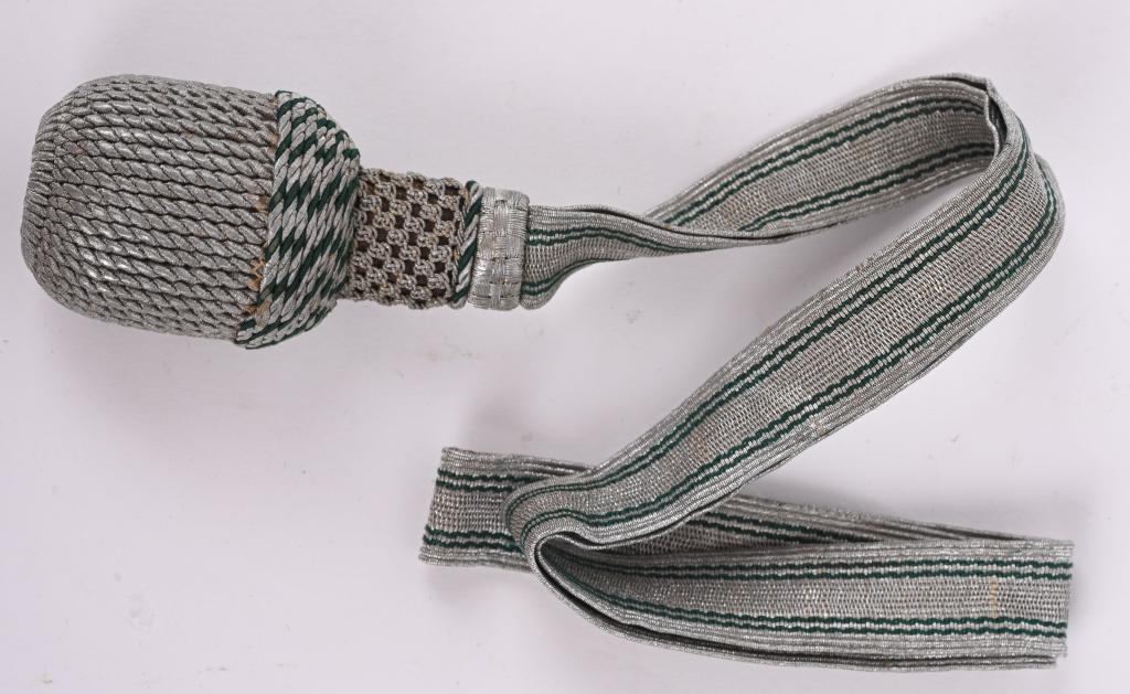 WWII NAZI GERMAN FORESTRY CUTLASS KNOT TRODDEL: This troddel is for a senior cutlas. The strapping consists of aluminum textured bullion have twin grain lines which run the length. There is a slide which consists of green and bullion “v”