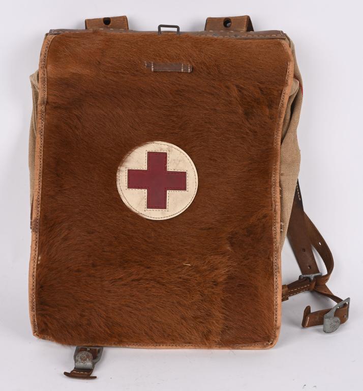 WWII NAZI GERMAN RED CROSS FUR BACK PACK W STRAPS: German Nazi Red Cross fur back pack and straps. Various stampings sat 44 on the straps and jng 44 and is waffenamt Waa441. Pack measures 11 1/2 X 16 inches with all the leather straps present and in e
