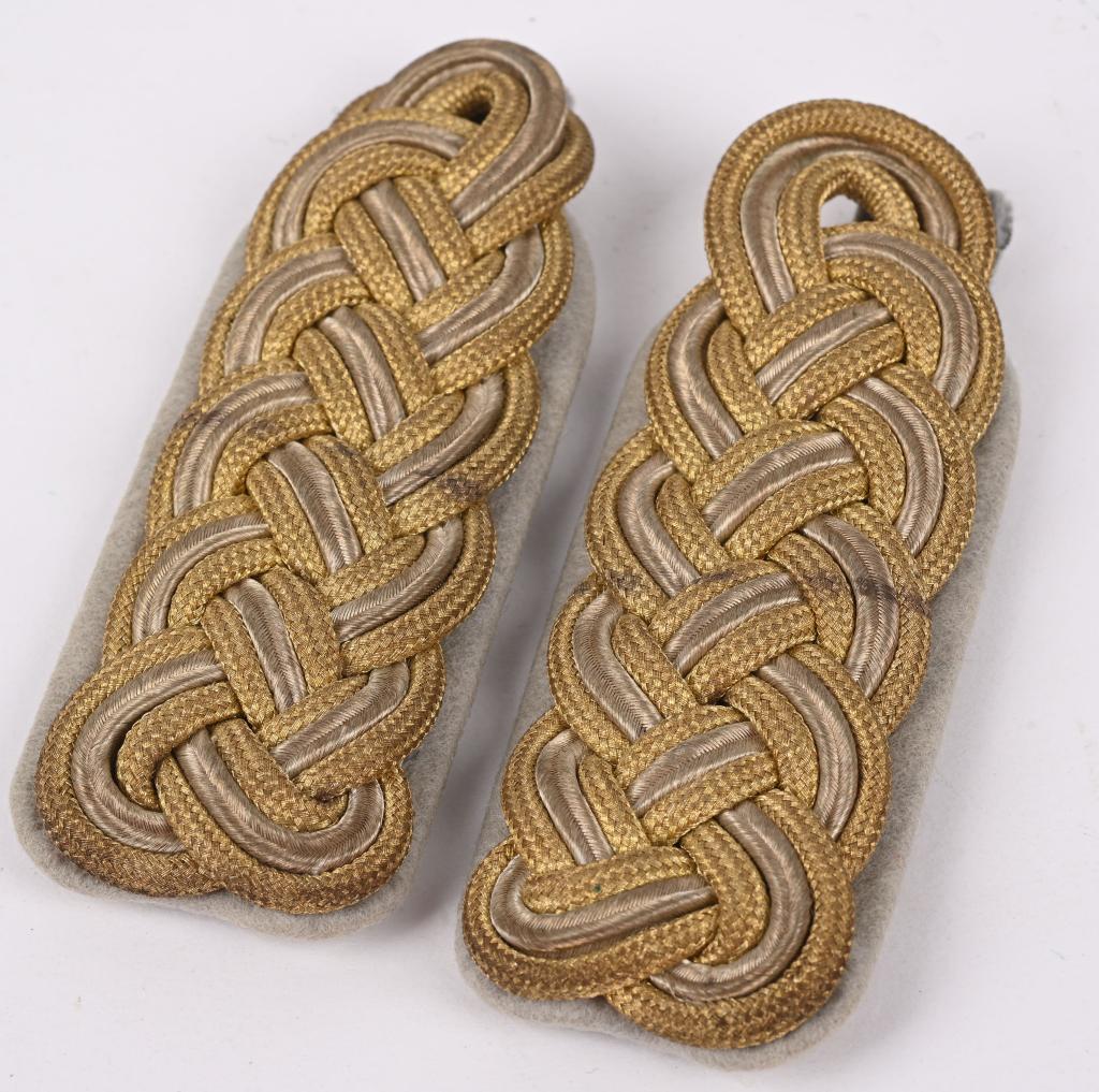 WWII NAZI GERMAN SS BRIGADEFUHRER SHOULDER BOARDS: (Waffen-SS Schulterklappen). A set of Waffen-SS Brigadeführer shoulder boards, each constructed of cardboard-reinforced light gray wool, bearing dual bands of interwoven gold bullion wire piping 