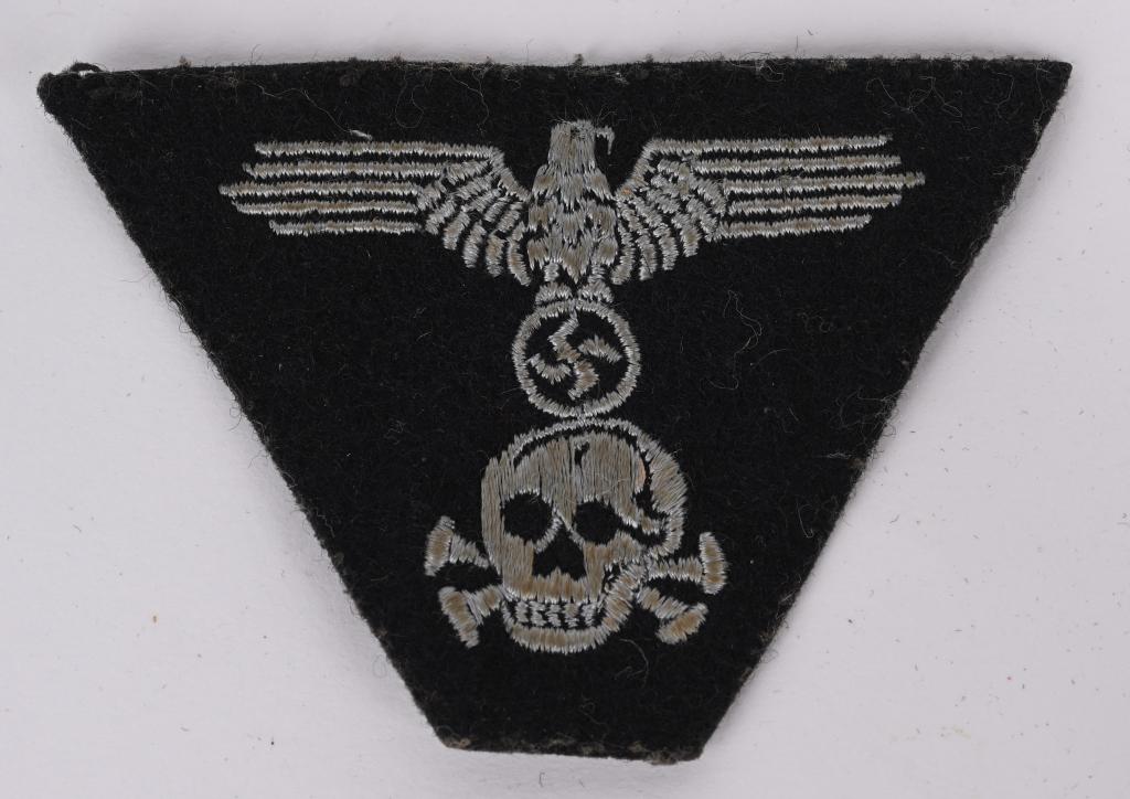 WWII NAZI GERMAN WAFFEN SS PANZER CAP INSIGNIA WW2: Panzer EM/NCO’s M43 Trapezoid Style Cap Insignia - of late War period manufactured, machine embroidered in silvery threads on black wool base, typical Dachau production, in excellent condition a