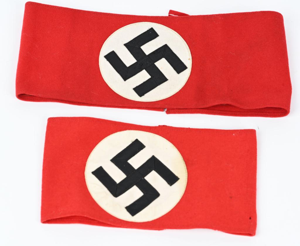 WWII INAZI GERMAN NSDAP WOOL PARTY ARMBANDS LOT: Lot of two red wool armbands, upon which is sewn a white disk, with a black, ribbed rayon tape mobile swastika sewn to it. Nice quality examples in excellent condition, both with RZM tags. P
