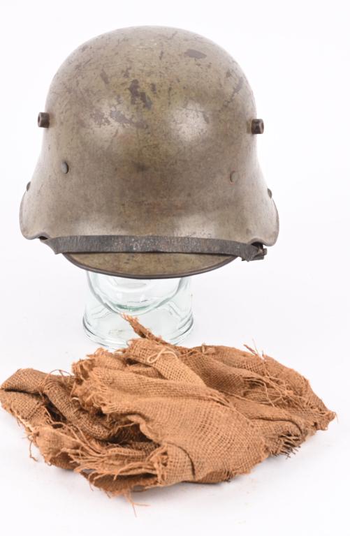 WW1 IMPERIAL GERMAN M16 HELMET w/ LINER CHINSTRAP: The stamped, sheet steel construction, helmet retains a good portion of its original field-gray paint. The helmet has all three flat headed, liner retaining rivets, both dome headed chinstrap retainin