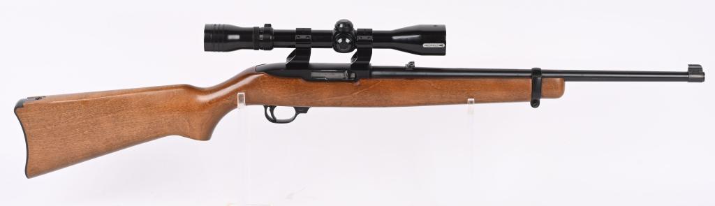RUGER MODEL 10/22 CARBINE WITH SCOPE: SERIAL NUMBER: 235-28103. BARREL: 18-1/2". CALIBER: .22LR. MANUFACTURED: 1992. Standard barrel weight with blade front sight and flip up u-notch rear. Original blued finish and oiled wood stock with p