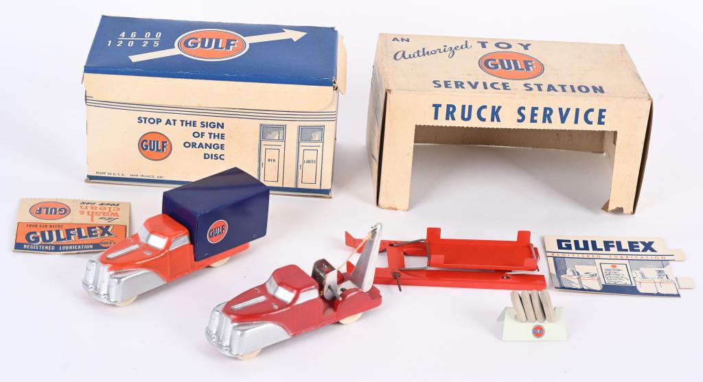 FRANCIS GULF SERICE STATION & TRUCKS w/ BOX: Great looking fold out box Gulf Service Station. Comes with 2 Trucks, Lift, Tire Rack, and Paper Displays. Box has metal door on side. Station measures 8" Truck measures 5 1/2" Excellent