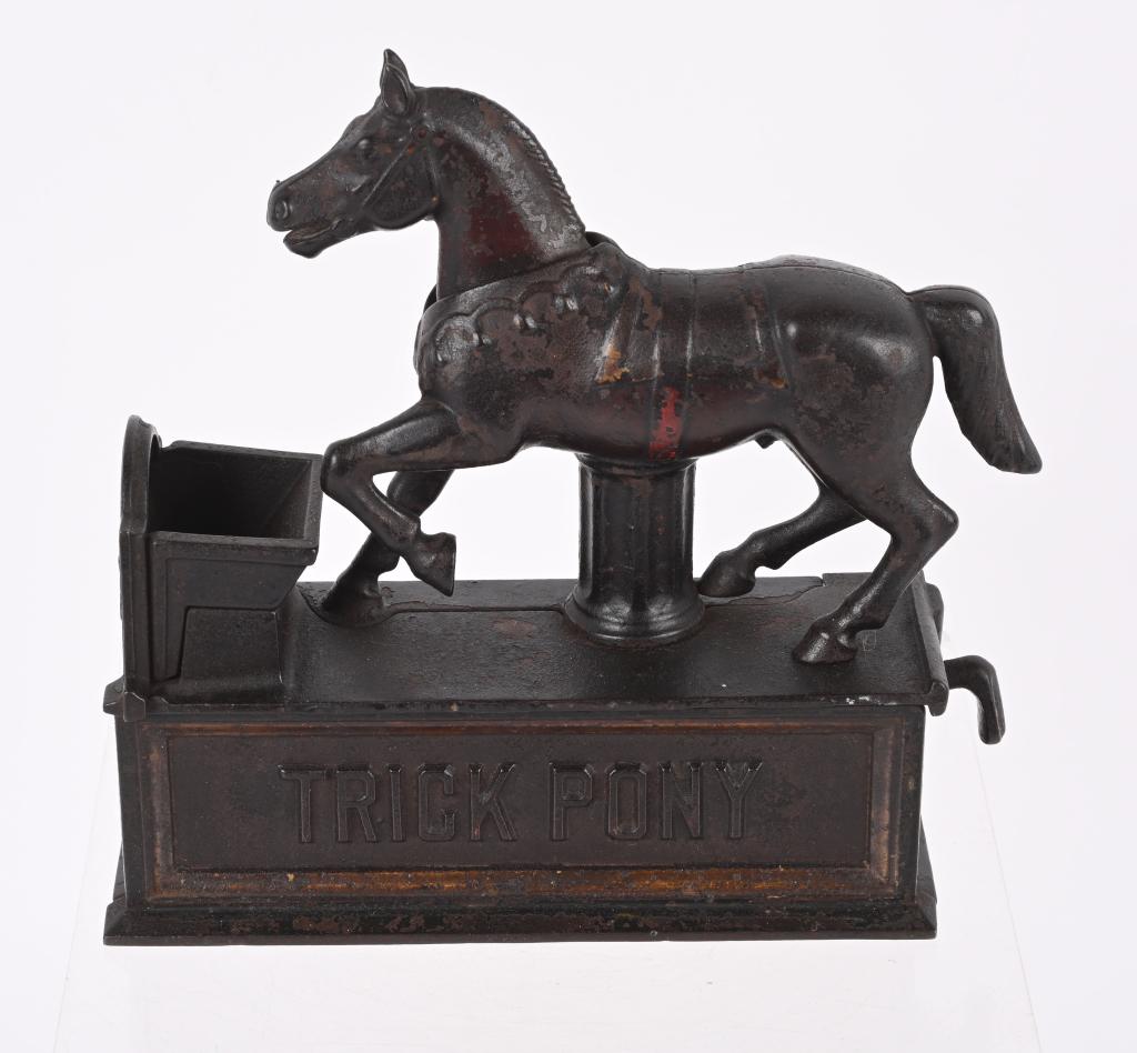 SHEPARD CAST IRON TRICK PONY BANK PAT. 1885: Made by Shepard Hardware, the bank is in original condition with no cracks or breaks. Action works. Paint is worn and the trap is missing. 7 1/2 L. by 7 3/4" H. Good-Very Good