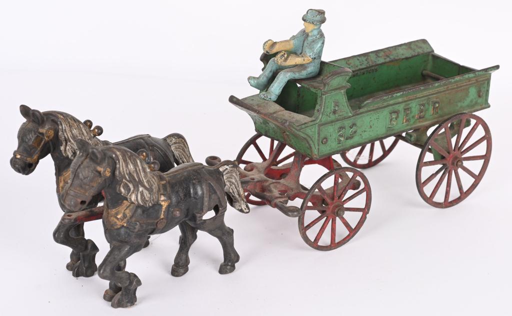 KENTON CAST IRON HORSE DRAWN BEER WAGON: Toy is in original condition with no cracks or breaks. Fixed front wheels under horses have been ground down flat. Driver is an original Arcade driver. May clean to a higher grade. 15" Very Good