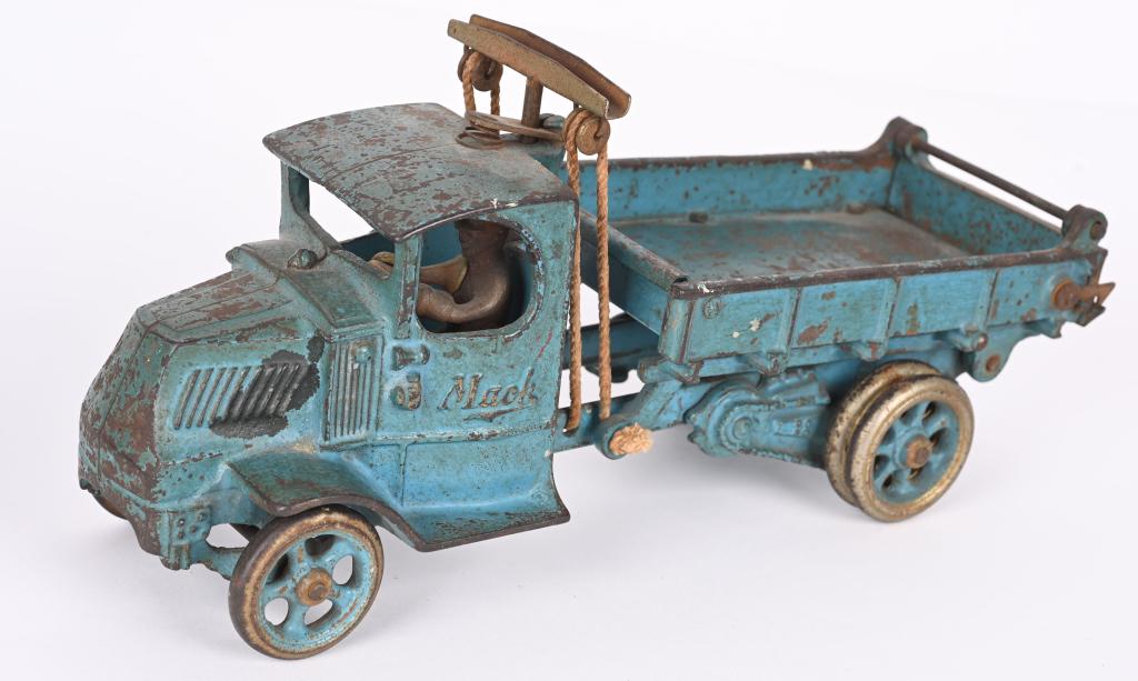 ARCADE CAST IRON LARGE MACK DUMP TRUCK: The truck is all original with no cracks or breaks. Has a paint drip on left side of bonnet. Driver is original and dump bed works. Should clean to a higher grade. 12". Very Good