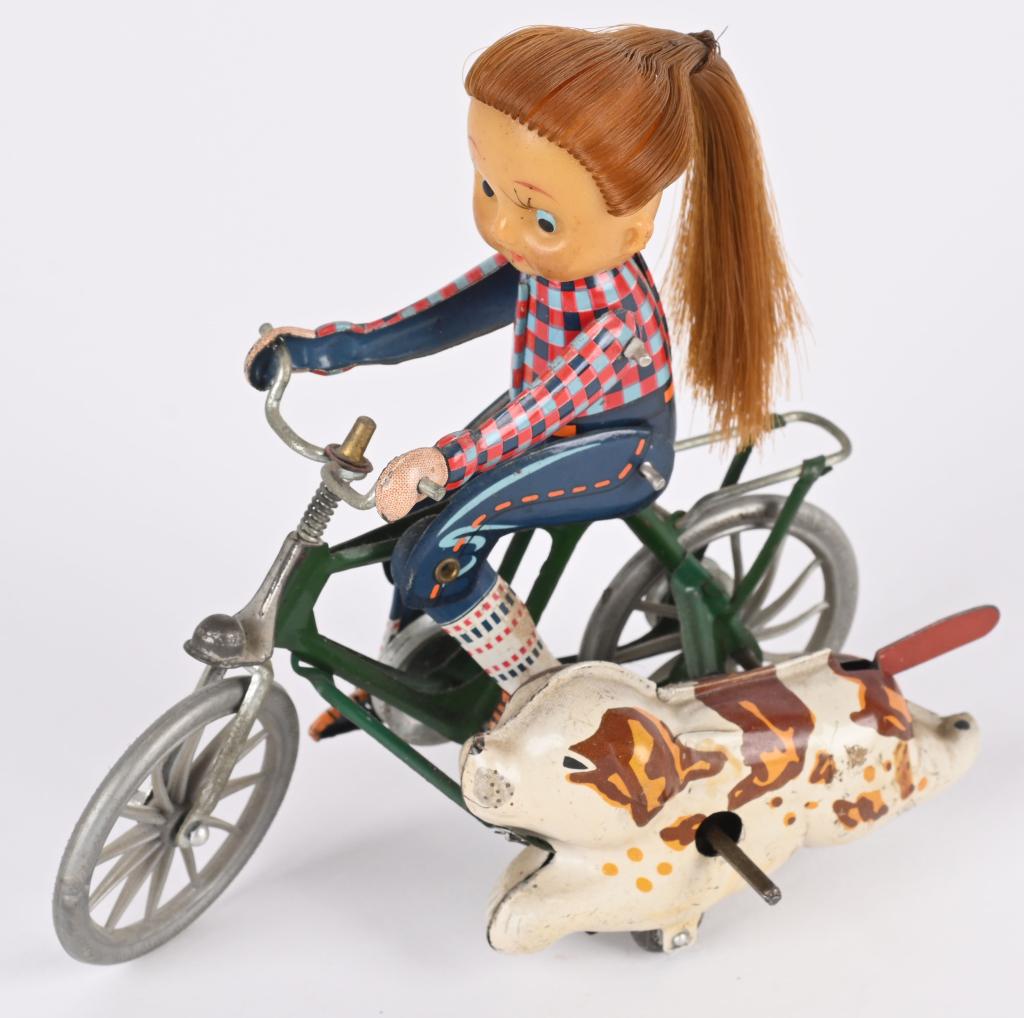 JAPAN WINDUP GIRL ON BIKE w/ DOG: All original and works. 5 1/2" Excellent