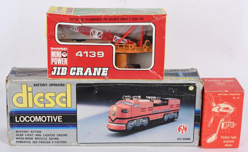 BATTERY OP LOCOMOTIVE, JIB CRANE, & ENGINE: Lot includes battery operated Diesel Locomotive, Shinsei Jib Crane, and Knickerbocker Pusher Type Airplane Motor. All Boxed. Largest 16" Excellent