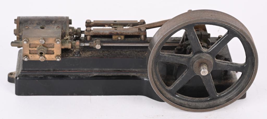 STUART CAST IRON STEAM MOTOR: Stuart live steam motor measures 8" long with a 3 3/4"" diameter wheel. Turns freely. Should clean to a higher grade. Very Good-Excellent