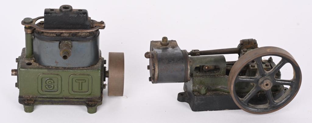 2- STUART CAST IRON STEAM MOTORS: One is 5" L by 4 1/2" H and is marked "ST". It appears to be missing a part from the top. The other cast iron motor is 6 1/4" long. Both turn over freely. Should clean to a higher grade. Very Good-Exc
