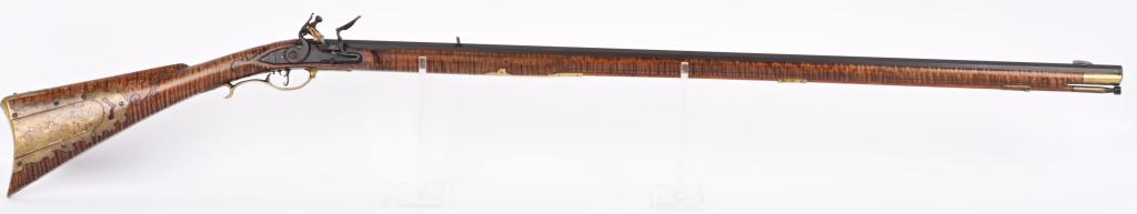 R.T.CASTER BUCKS COUNTY KY FLINTLOCK RIFLE: BARREL 42 1/4". CALIBER 50. Super high quality contemporary custom flintlock features full octagon barrel, single leaf rear sight, full length incised striped maple stock, brass furniture with engrave